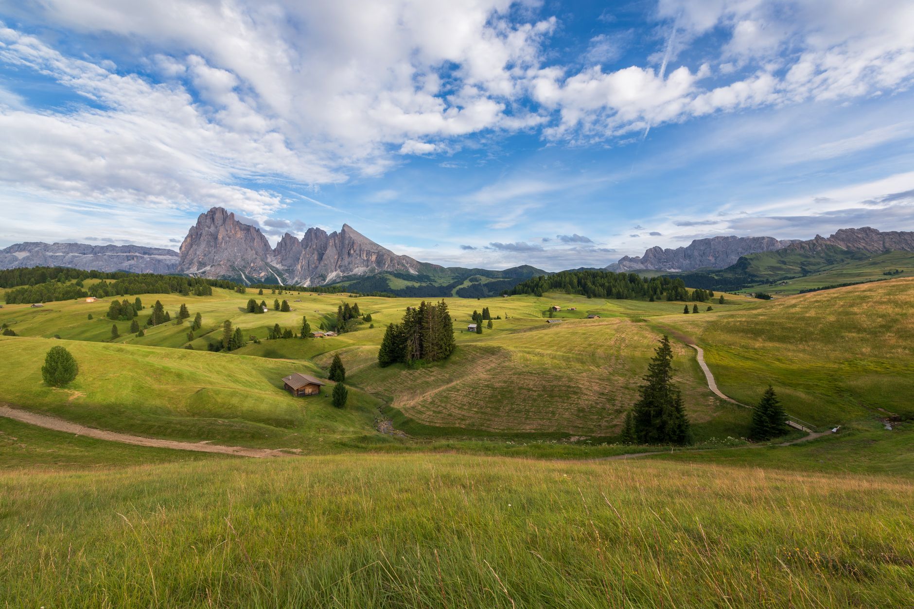 Sun breaking over the jagged ridges of the Italian Dolomites